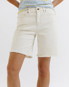 White denim shorts worn by a person on a white background