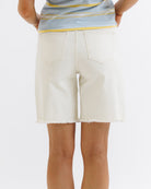White denim shorts worn by a person on a white background