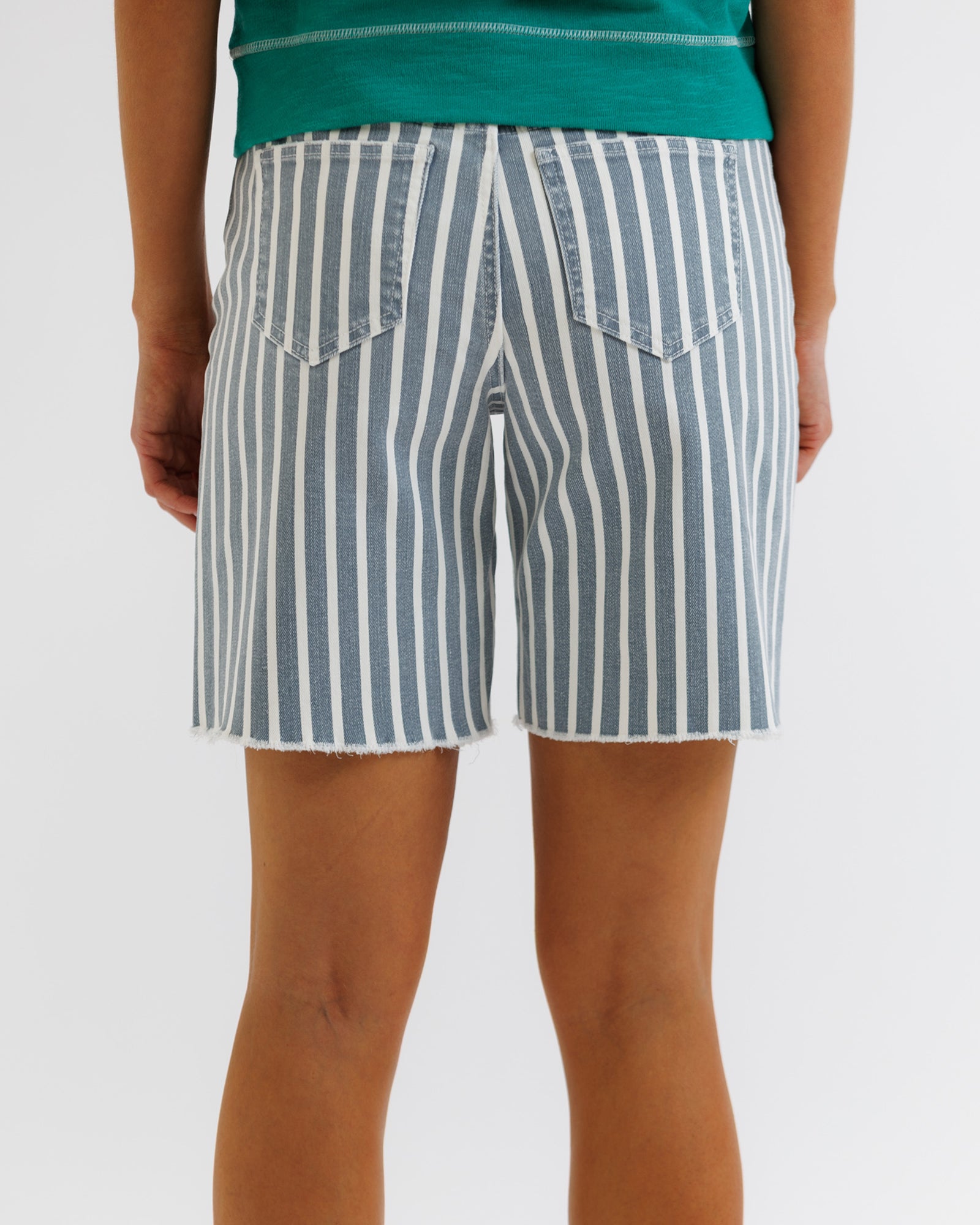 Person wearing blue and white striped shorts on a plain background