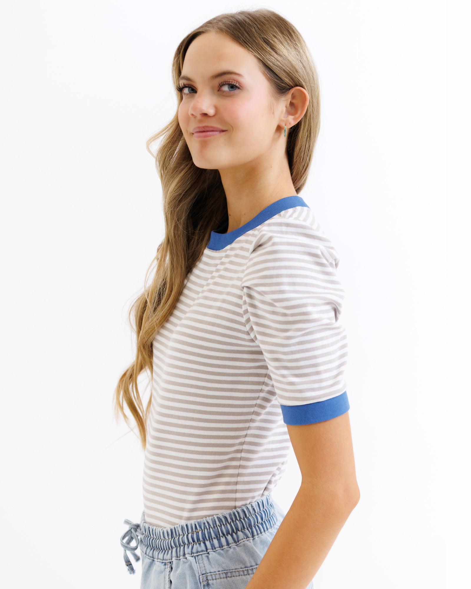 Woman wearing a striped shirt with blue sleeves on a white background