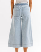 Light blue denim culottes worn by a person on a white background