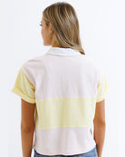 Woman wearing a striped polo shirt with a white background