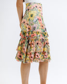 Floral tiered skirt worn by a person on a white background