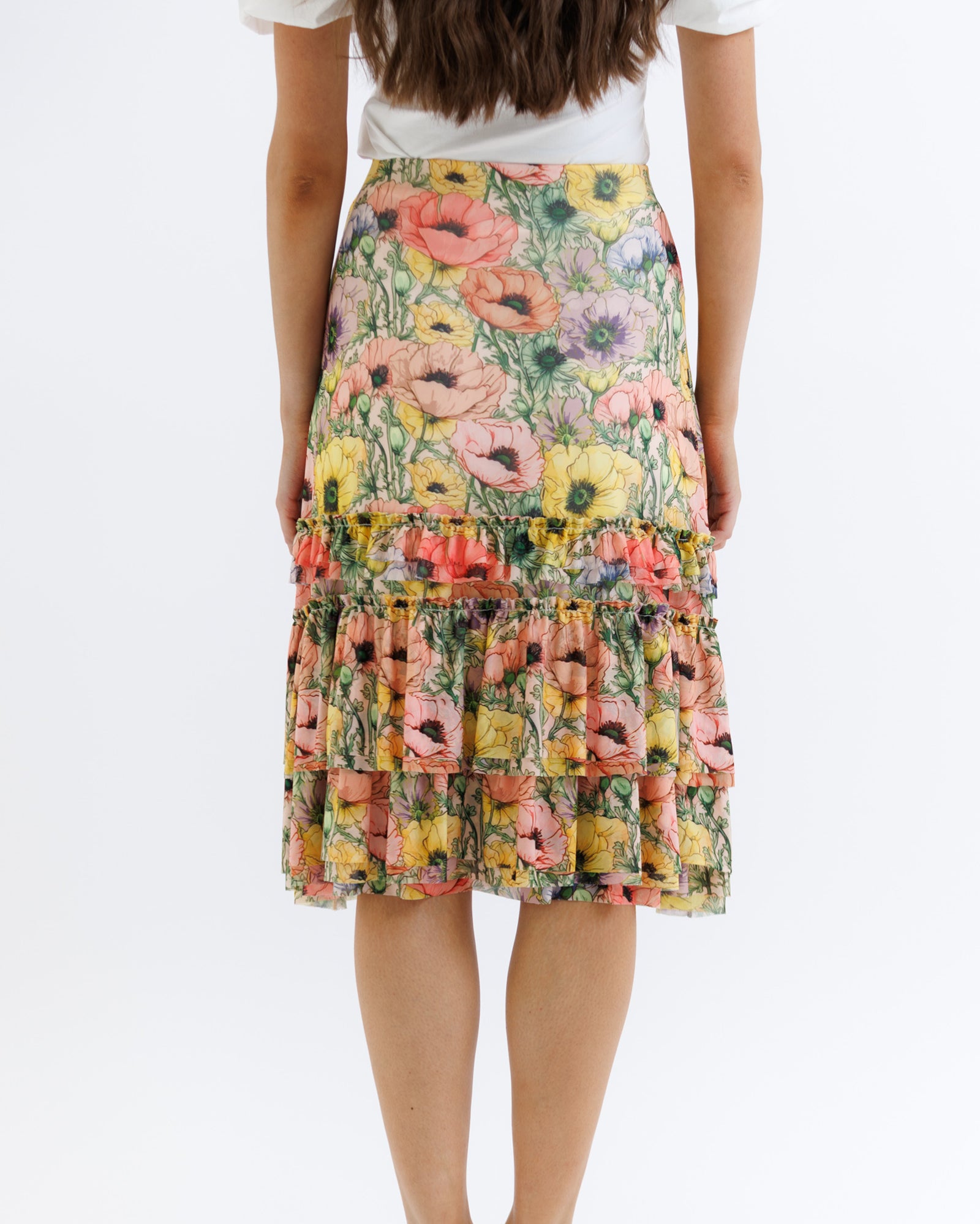 Floral tiered skirt worn by a person on a white background