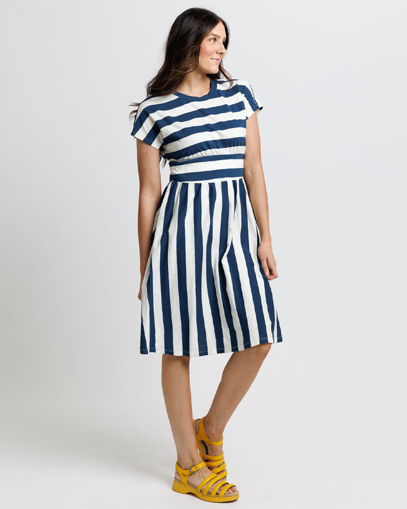 Model wearing a navy and blue striped short sleeve midi length knit dress
