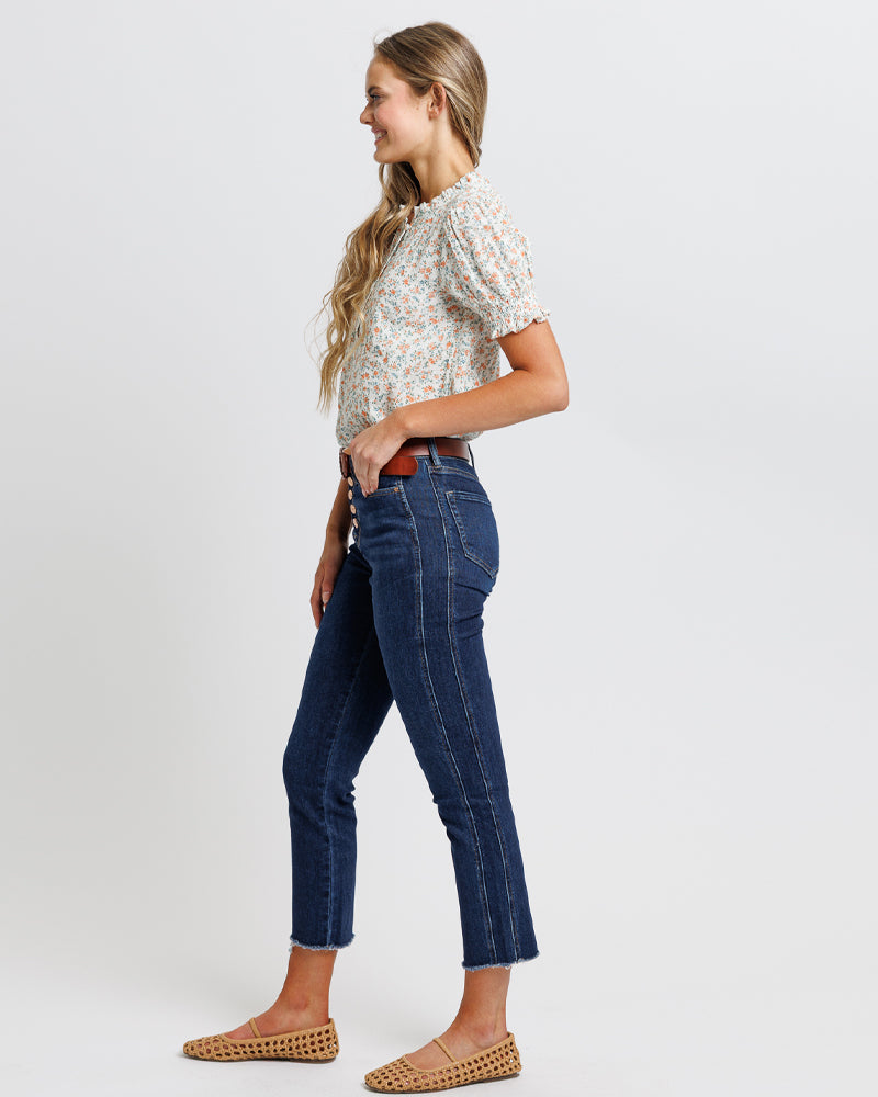 Model wearing dark blue mid-rise cropped denim jeans.