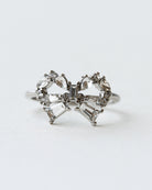 Diamond butterfly ring on a light gray background