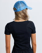 Model wearing a black short sleeve scoop neck tee