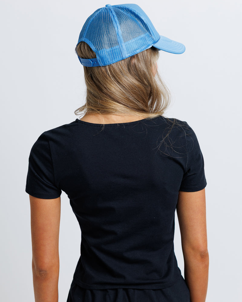 Model wearing a black short sleeve scoop neck tee