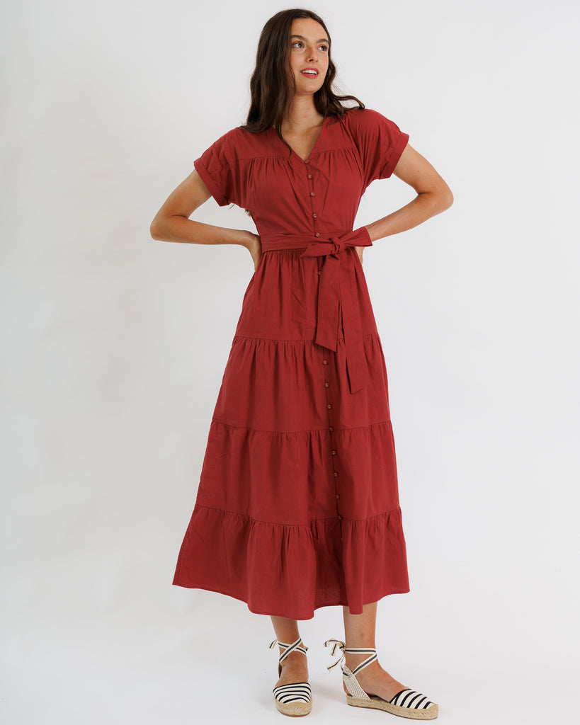 Model wearing a red short sleeve v-neck tiered skirt maxi dress