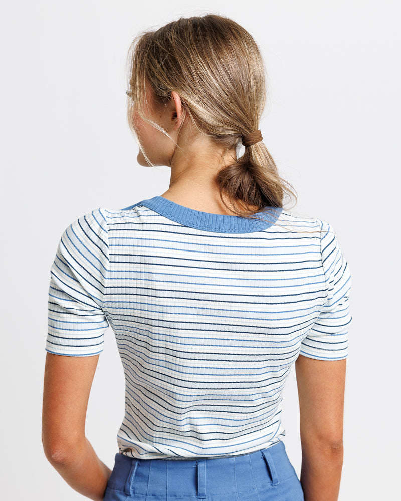 Model wearing a light blue striped short sleeve boat neck tshirt