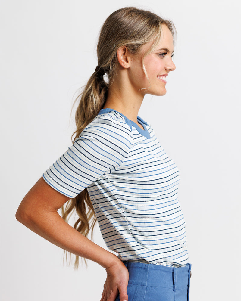 Model wearing a light blue striped short sleeve boat neck tshirt