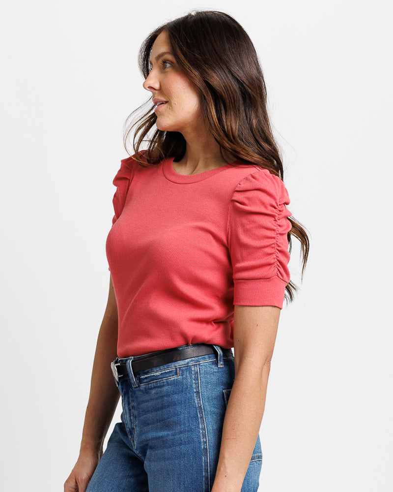 Model wearing a red short sleeve with ruching crew neck top
