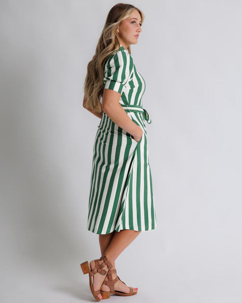 Model wearing a whtie and green vertical striped short sleeve collared button-down midi dress