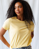 Woman wearing a yellow t-shirt against a white background