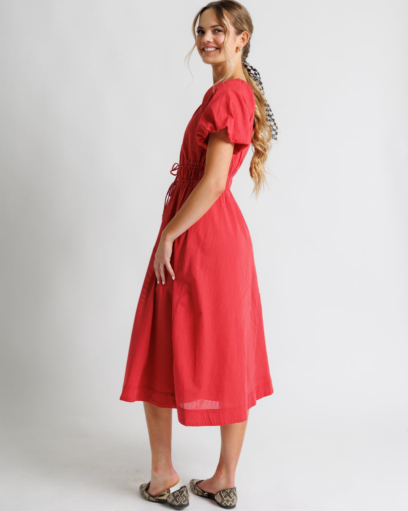 Model wearing a red short puffed sleeve scoop neck midi dress.