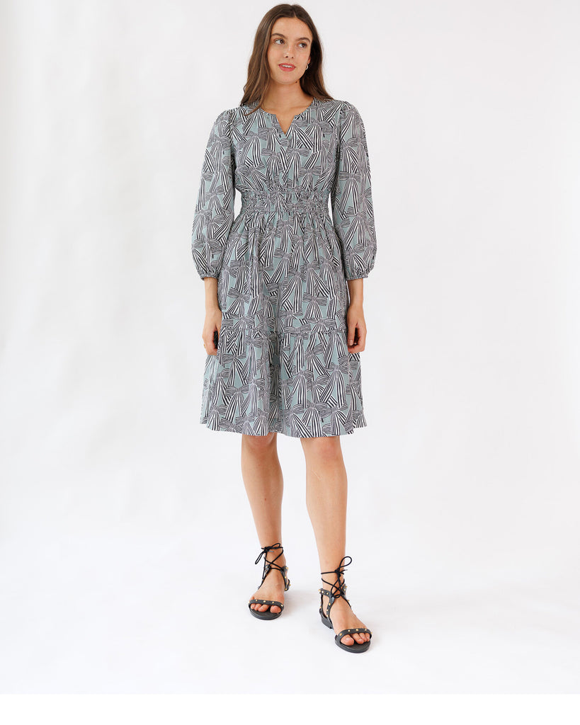 Woman wearing a patterned dress on a white background