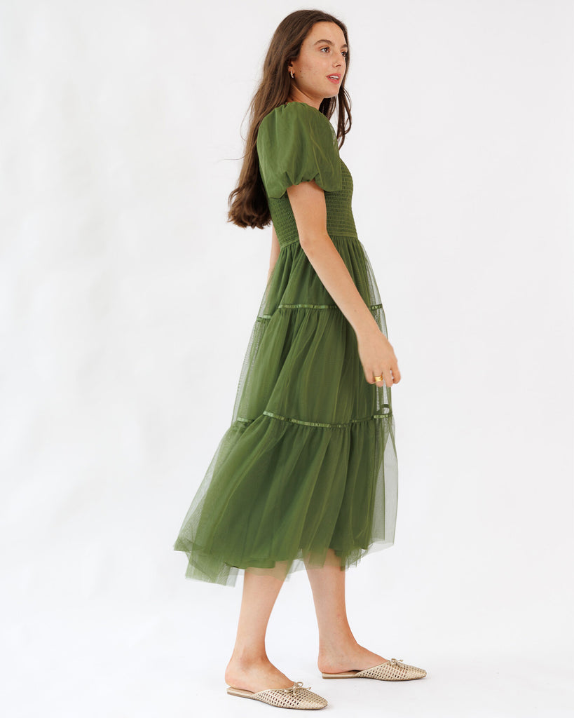 Woman wearing a green dress on a white background