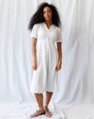 Woman wearing a light blue dress against a plain white background