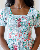 Woman wearing a floral dress with a white background