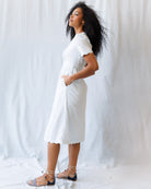 Woman wearing a light blue dress against a plain background