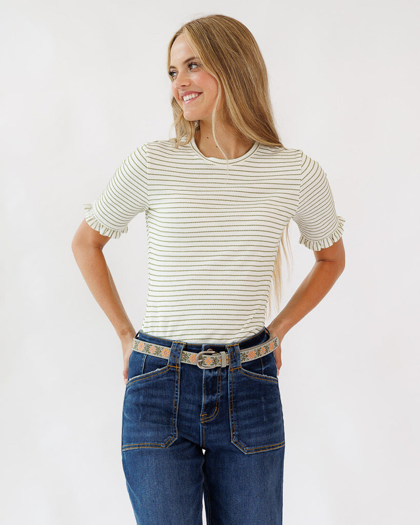 Woman wearing a striped shirt and jeans on a white background