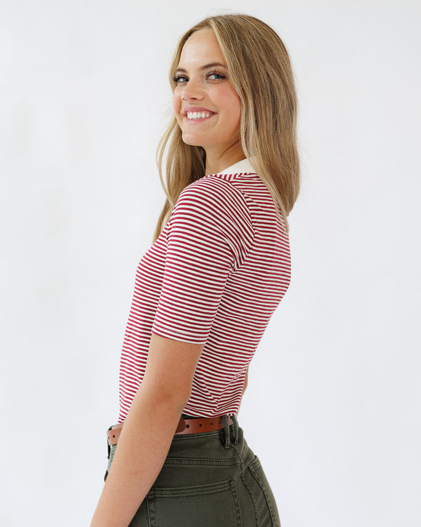Woman wearing a red and white striped shirt against a white background
