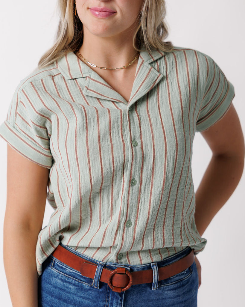 Model wearing a green striped short sleeve collared buttondown