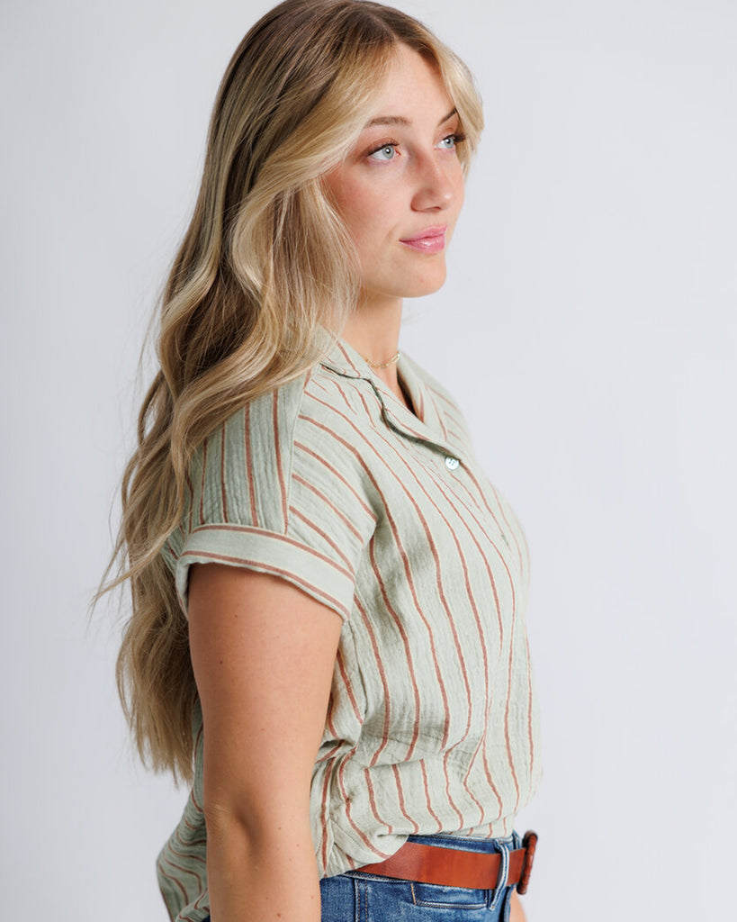 Model wearing a green striped short sleeve collared buttondown