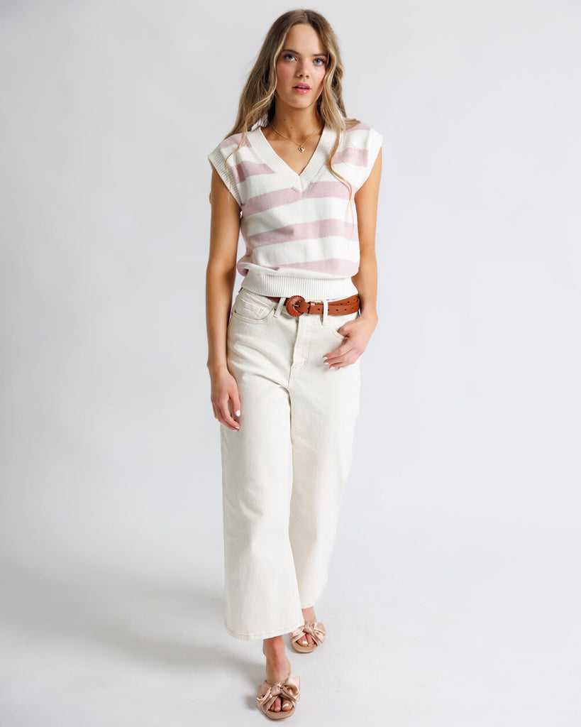 Model wearing white high rise wide leg cropped jeans.