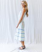 Woman wearing a striped dress against a white background