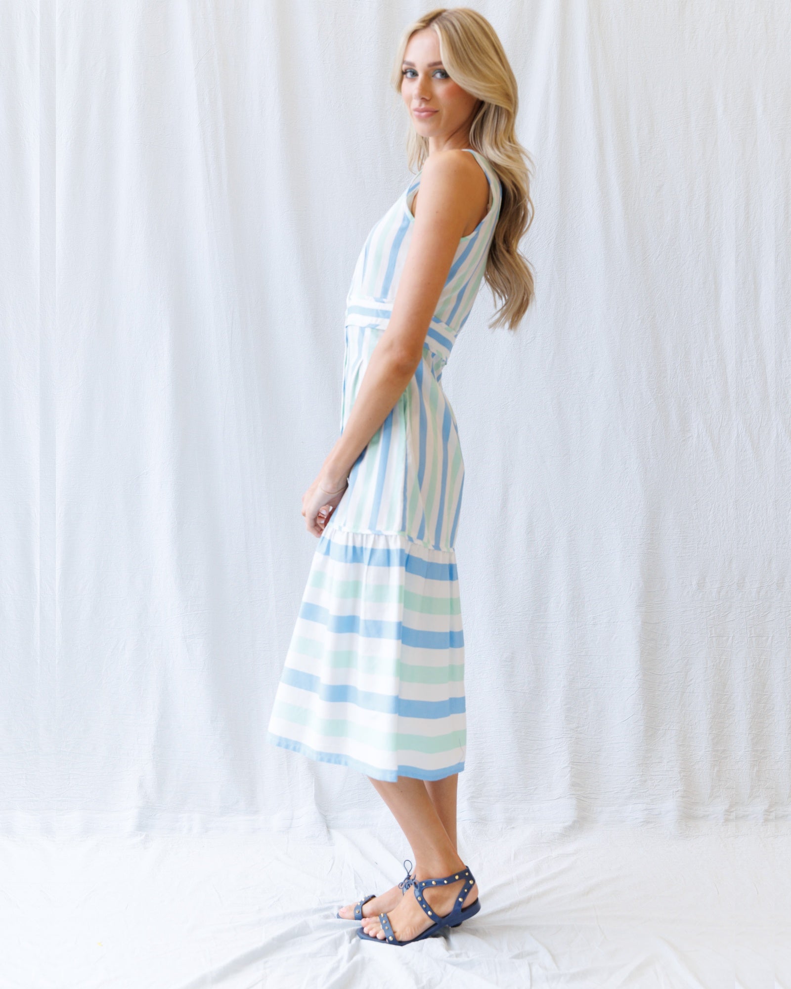 Woman wearing a striped dress against a white background
