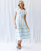 Woman wearing a striped dress against a white background