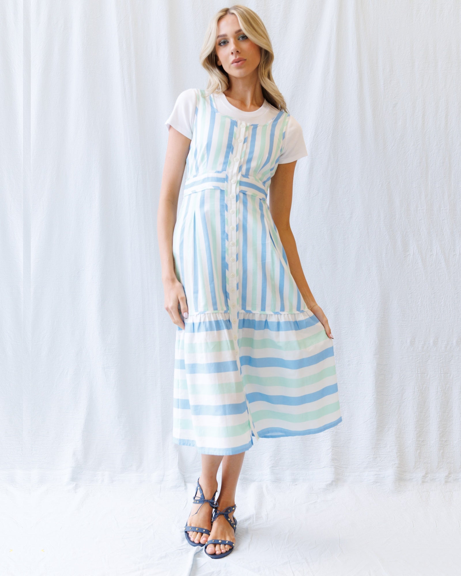 Woman wearing a striped dress against a white background