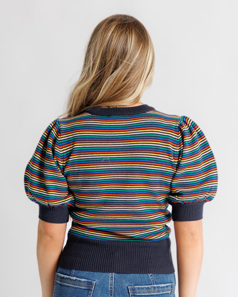Model wearing a black with bright stripes short puffed sleeve crew neck pullover.