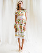 Woman wearing a floral dress against a white background
