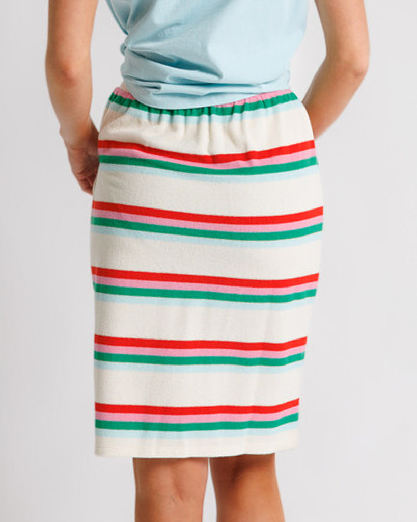 Model wearing a white, pink, green and blue striped short flutter sleeve terry knee length skirt.