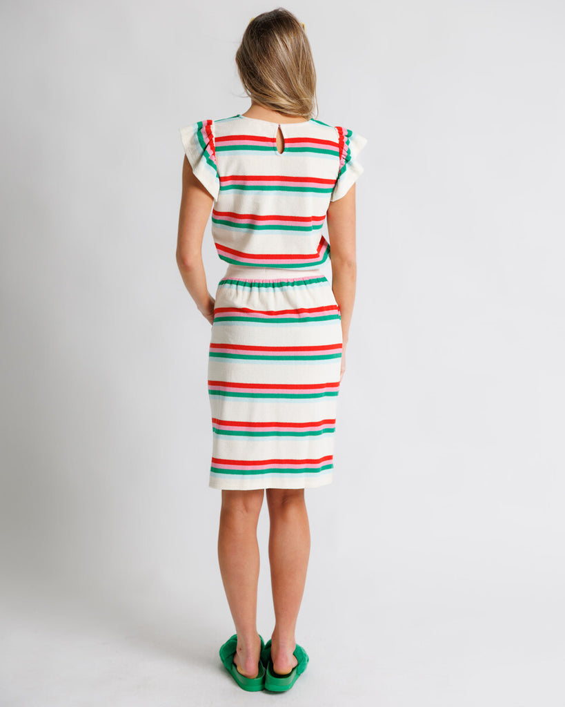 Model wearing a white, pink, green and blue striped short flutter sleeve terry knee length skirt.