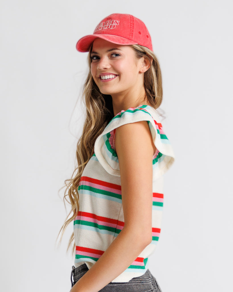 Model wearing a white, pink, green and blue striped short flutter sleeve terry top