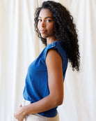 Woman wearing a blue top with a neutral background