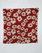 Red fabric with white floral pattern on a white background
