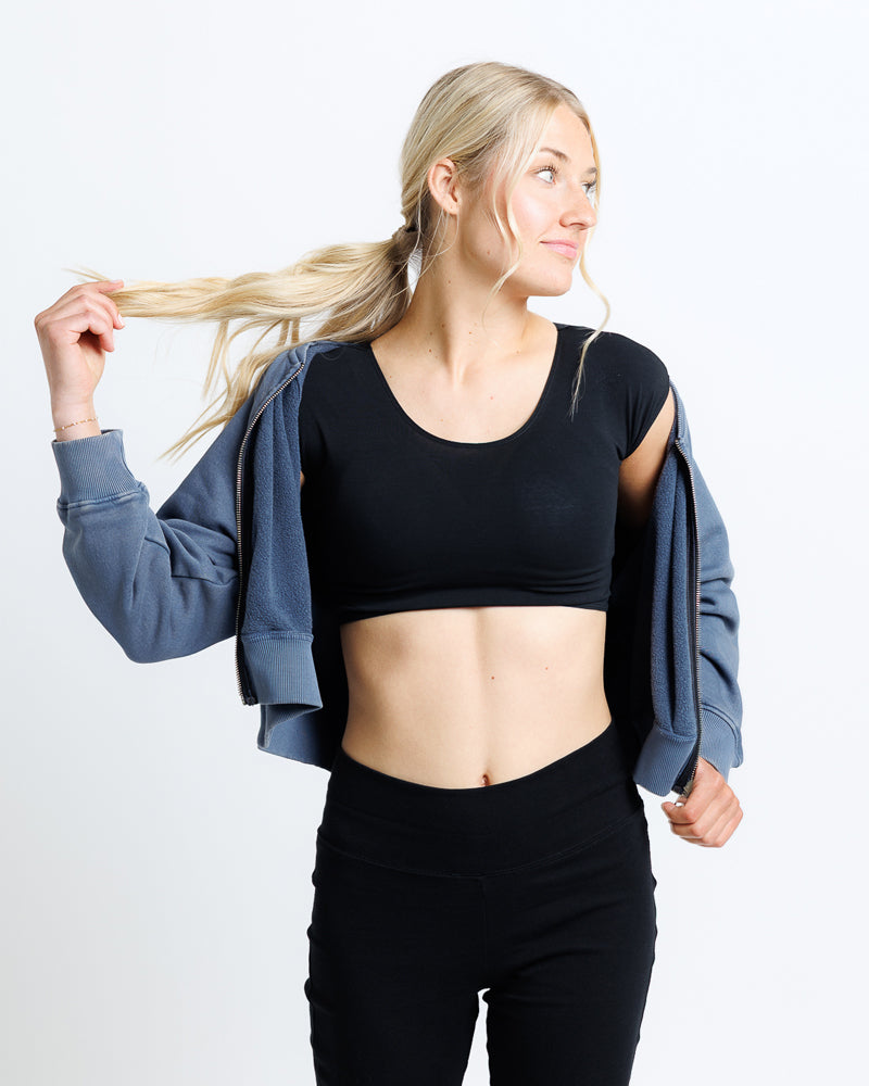 Model wearing a black short sleeve scoop neck cropped tee.