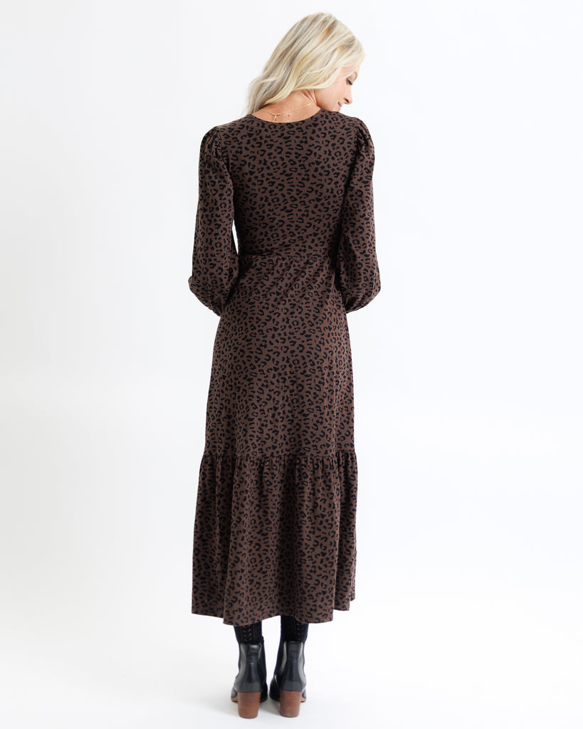 Woman wearing a brown leopard print dress on a white background