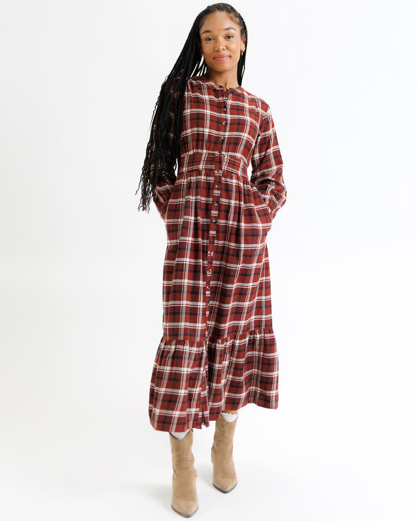 Woman wearing a red and white plaid dress on a white background