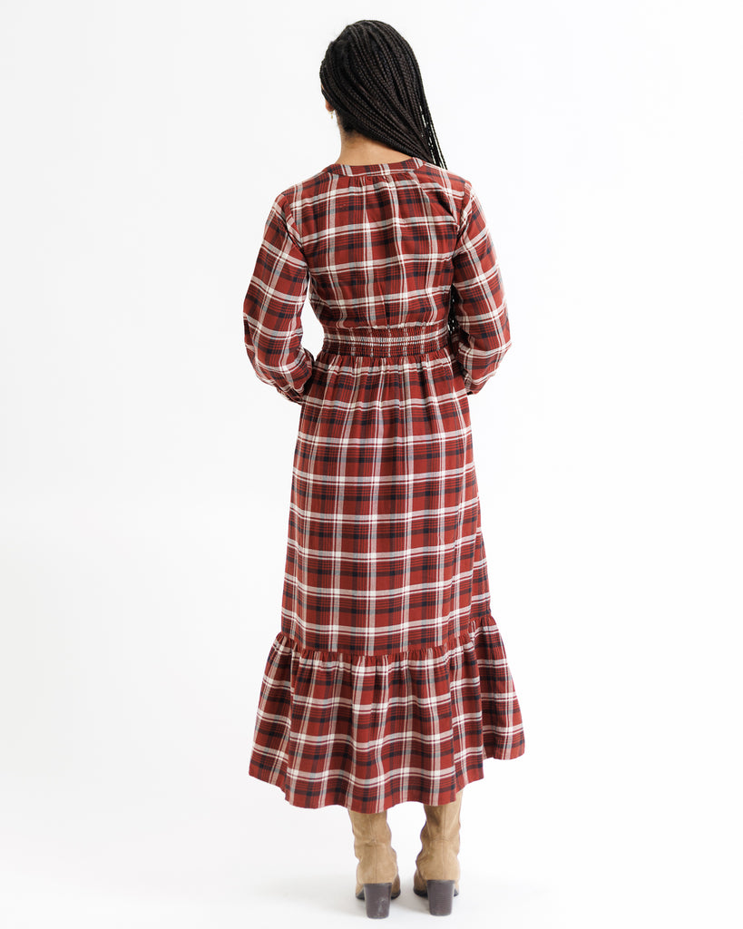 Person wearing a red and white plaid dress on a white background
