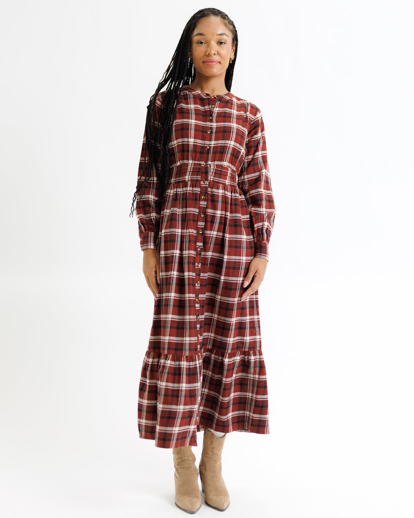 Woman wearing a plaid dress on a white background