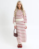 Woman wearing a red and white striped dress on a white background