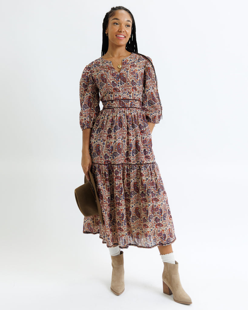 Woman wearing a floral dress with a plain background
