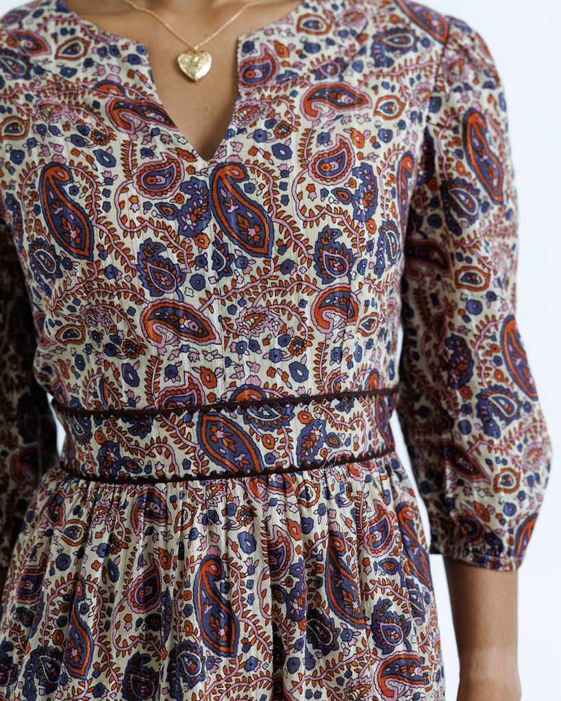 Patterned dress with long sleeves on a plain background