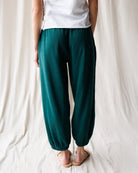 Up close image of a woman wearing teal pants